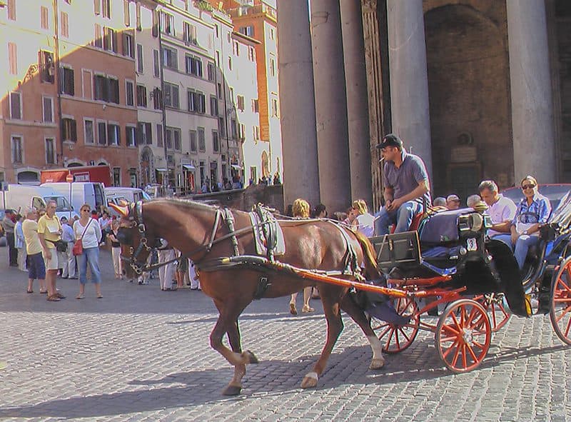 people in a horse-drawn carriage in one of the hidden gems in Europe