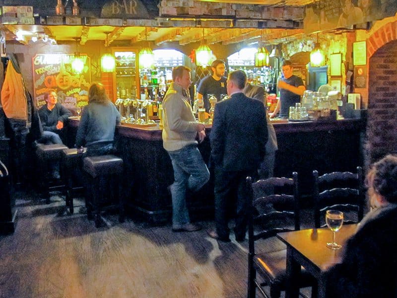 two men standing and talking in an old bar in Scotland
