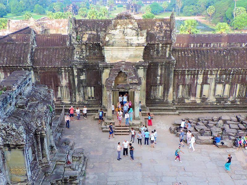 people walking in a temple while visiting Angkor Wat