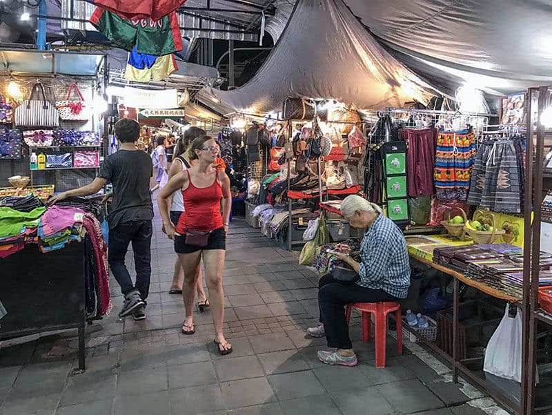 people walking through a night market,  one of the things to do in chiang mai
