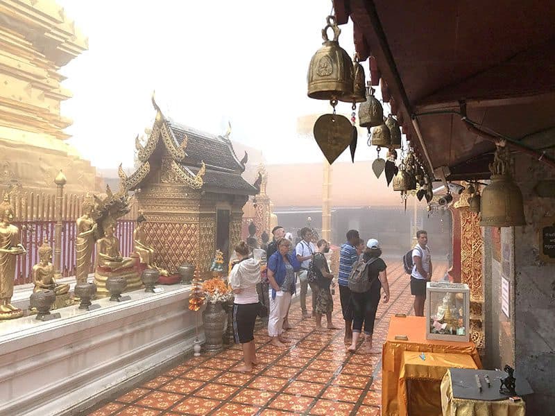 People visiting a temple on a mountaintop,  one of the things to do in chiang mai