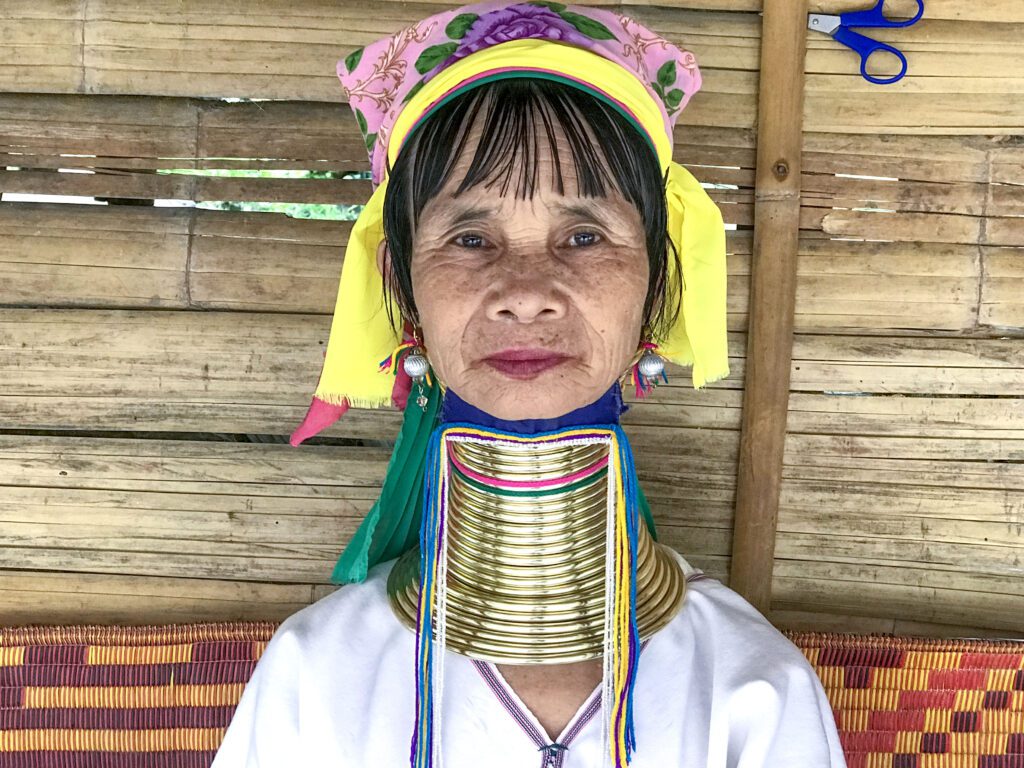 a tribal woman with large brass rings around her neck