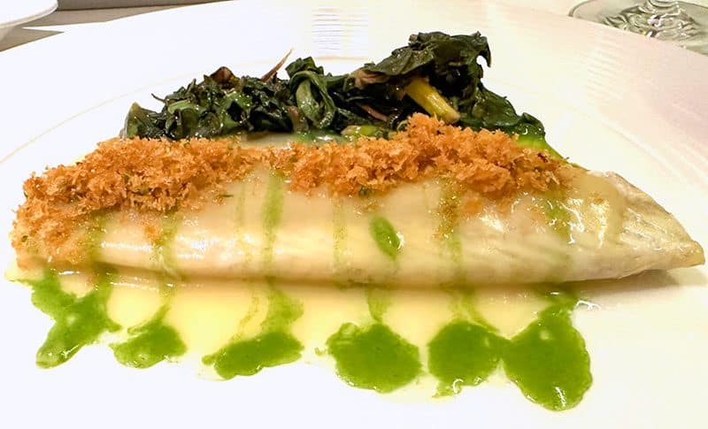 a large piece of fish on a plate on the Crystal Serenity