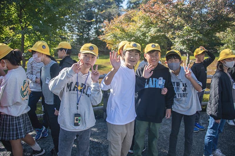 Japanese boys waving to the camera