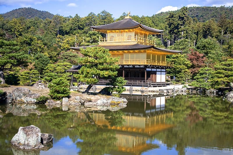 a temple covered with gold leaf on the side of a lake – one of the things to do and see in Kyoto