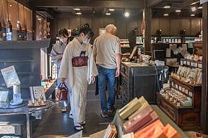 A woman in a kimono shopping in a store