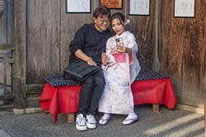 a Japanese many and woman taking a selfie - one of the things to do in Kyoto