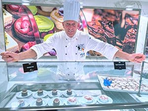 a chef showing the pasteries he has created