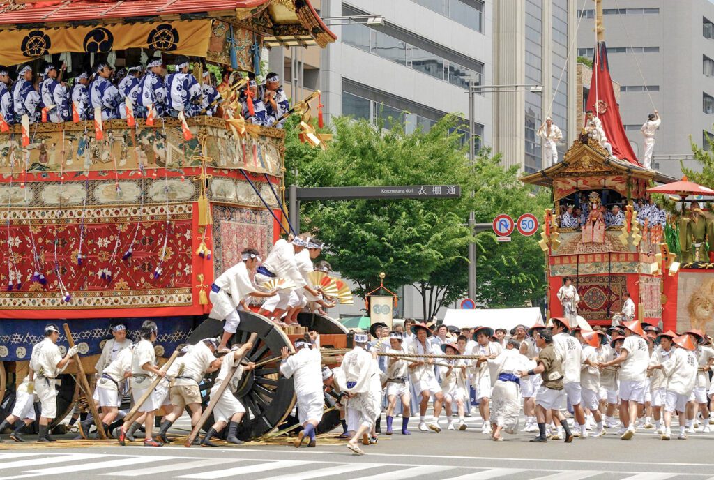 men pulling huge floats in a festival in Kyoto