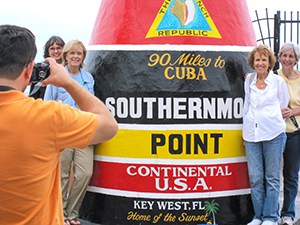 people being photographed by a large buoy in the Florida Keys