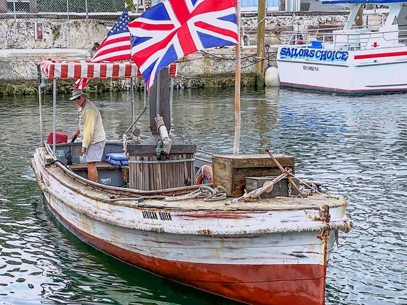 a man steering the African Queen in the Florida Keys