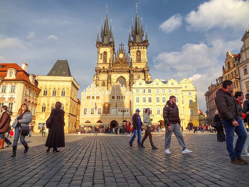 people walking through an old European square -- how to budget for a trip