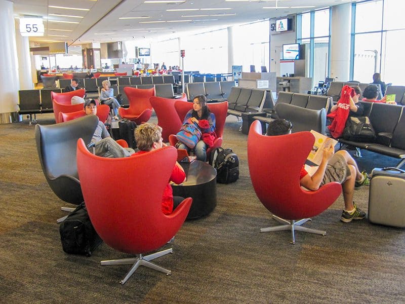 people sitting near the boarding gate at an airport