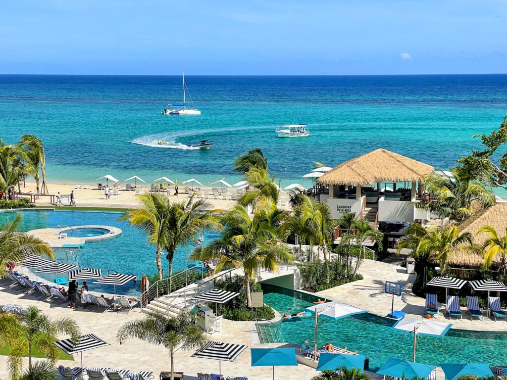 a Carribean beach with boats offshore at Sandals Dunns River Resort