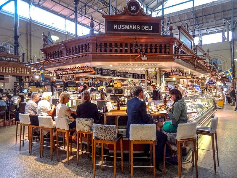 people sitting in an old food hall in Europe