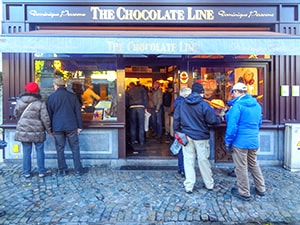 people standing outside a coffee shop