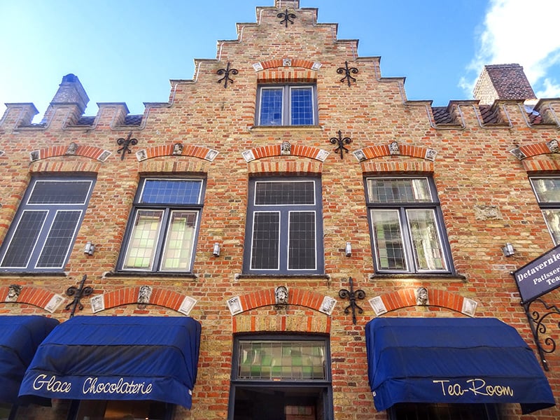 the ornate Gothic facade of a building - one of things to do in Bruges