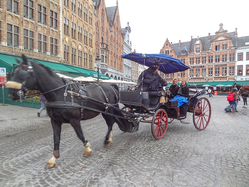 people taking a carriage ride - one of things to do in Bruges