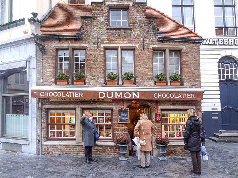 three women outside an old cottage that been converted to a chocolate shop