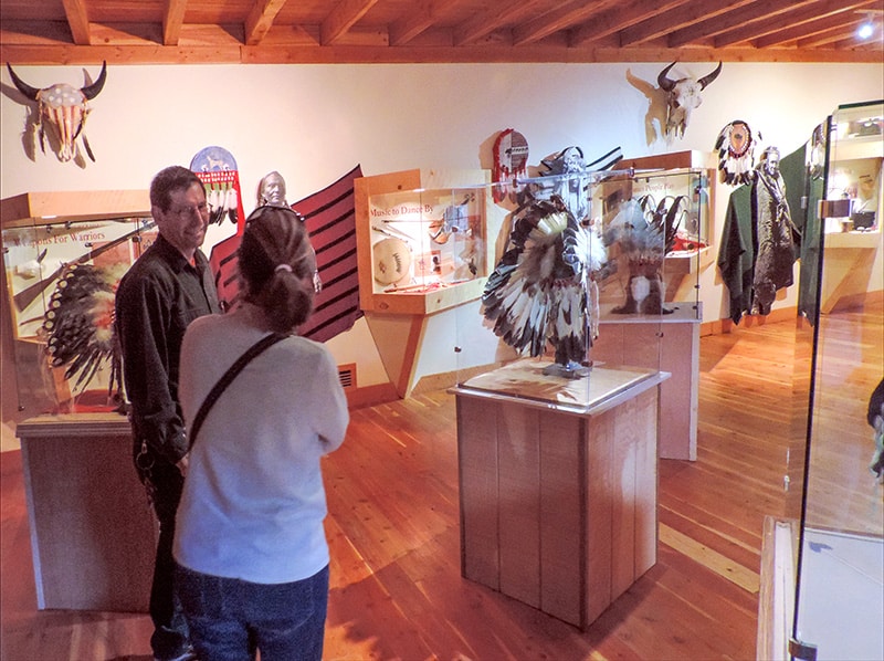 man and woman looking at a native people's headdress in Fort Benton MT