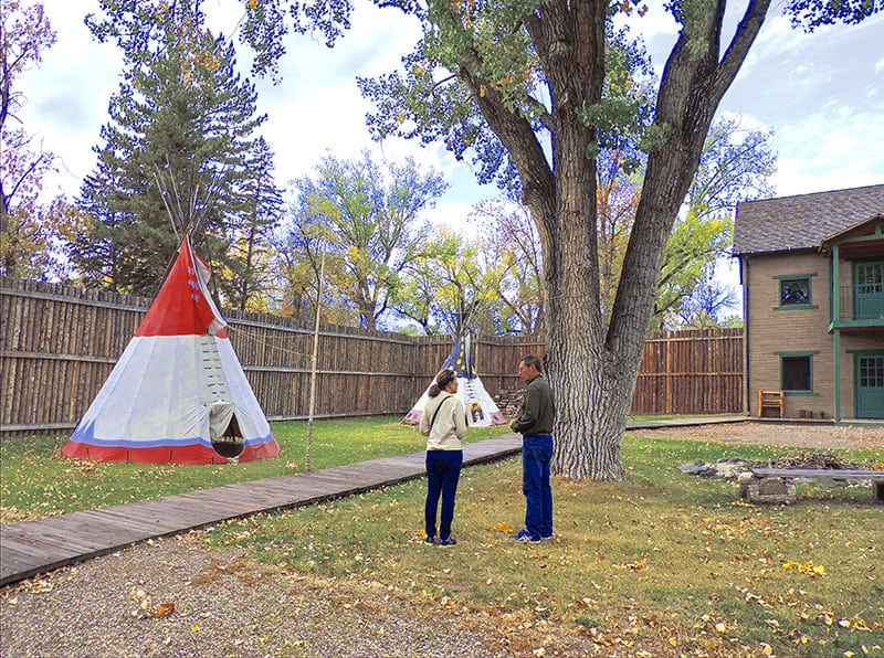 woman and man inside a fort with a teepee in Fort Benton MT