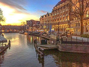 sunset over a canal lined by ancient buildings seen during 2 days in Amsterdam