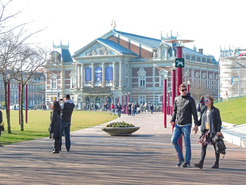 people walking through a city park