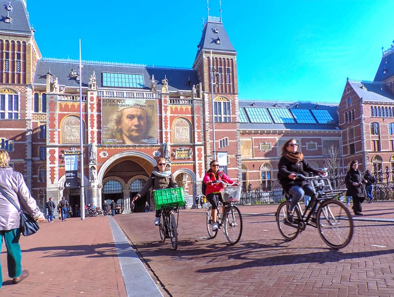 bicyclists by a large ornate building seen during 2 days in Amsterdam