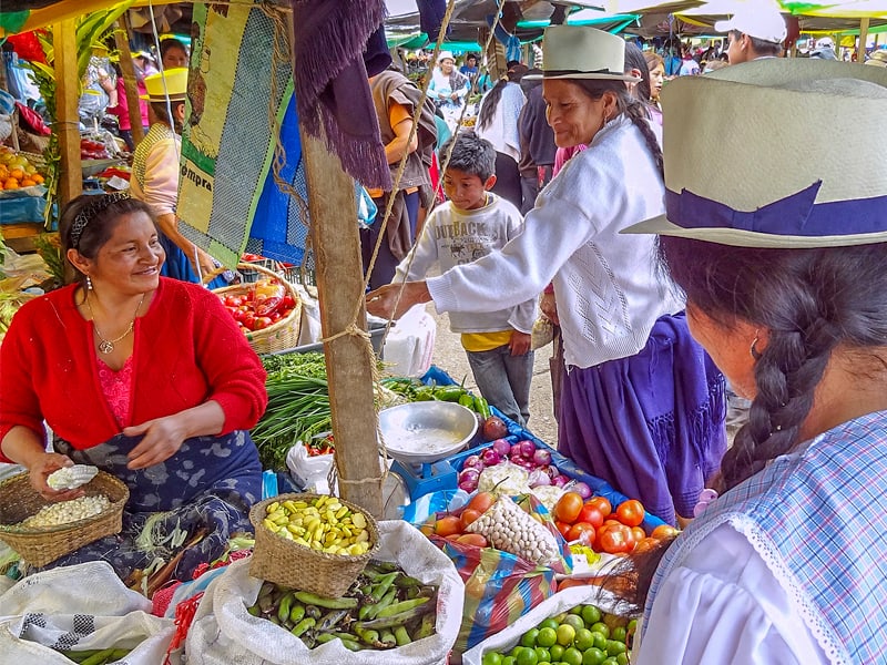 people in a colorful market - one of the things to do in Cuenca
