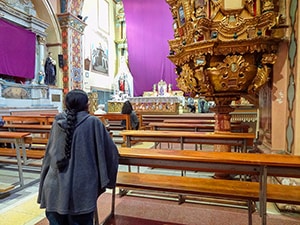 a woman praying in a church