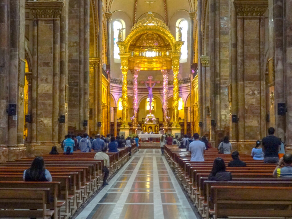 people in a huge ccathedral - - one of the things to do in Cuenca