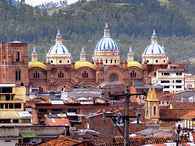 3 brightly painted blue and white domes of a church 