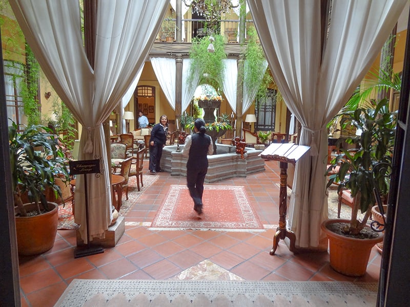 two people in the ornate lobby of a hotel