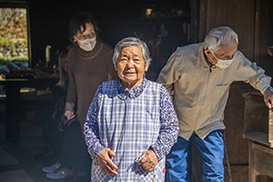 an old Japanese lady speaking to a group of people