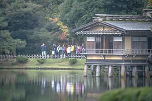 people by a tea house on a lake