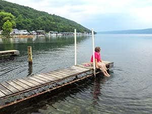 a woman sitting on a floating dock
