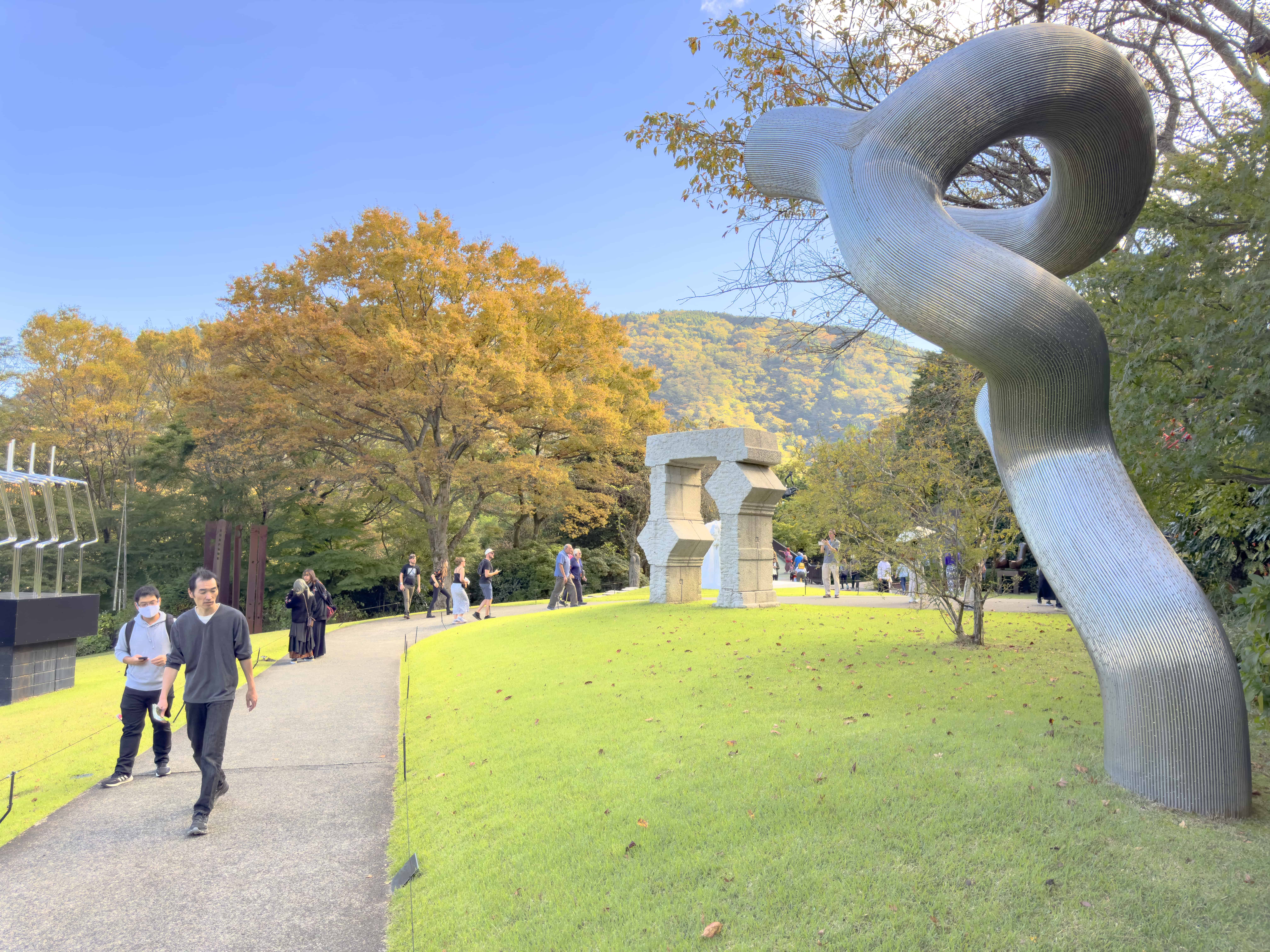 people walking through a huge outdoor sculpture garden, one of the things to do in Japan