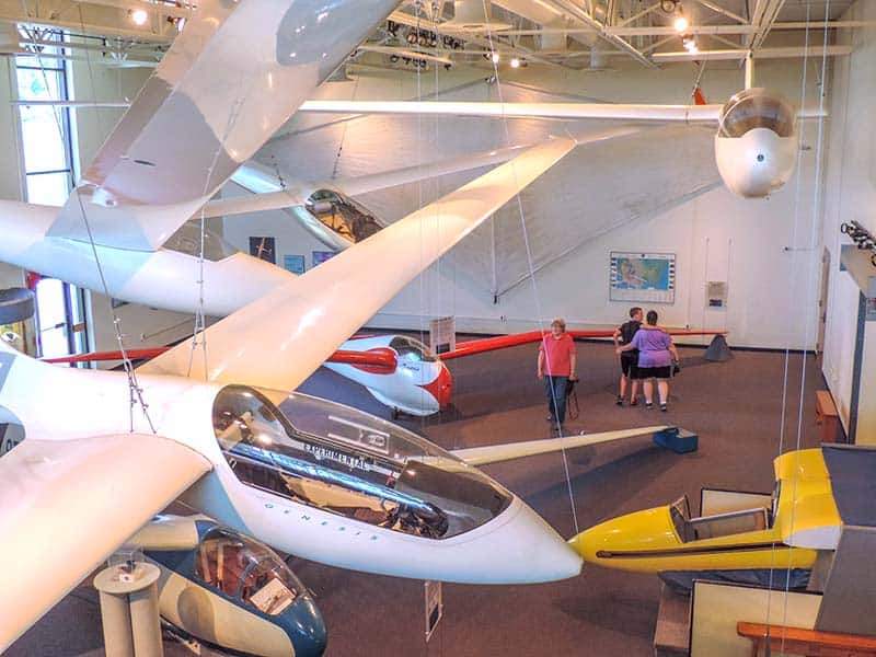planes hanging from the ceiling in a glider museum