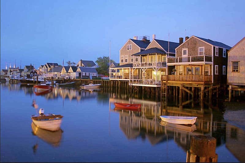 boats in a quiet harbor at sunset –nantucket vs marthas vineyard