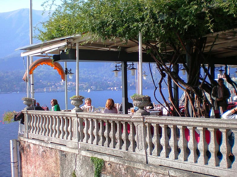 people in an outdoor restaurant on Lake Como