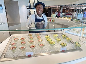 a server at a food station onboard the Explora 1
