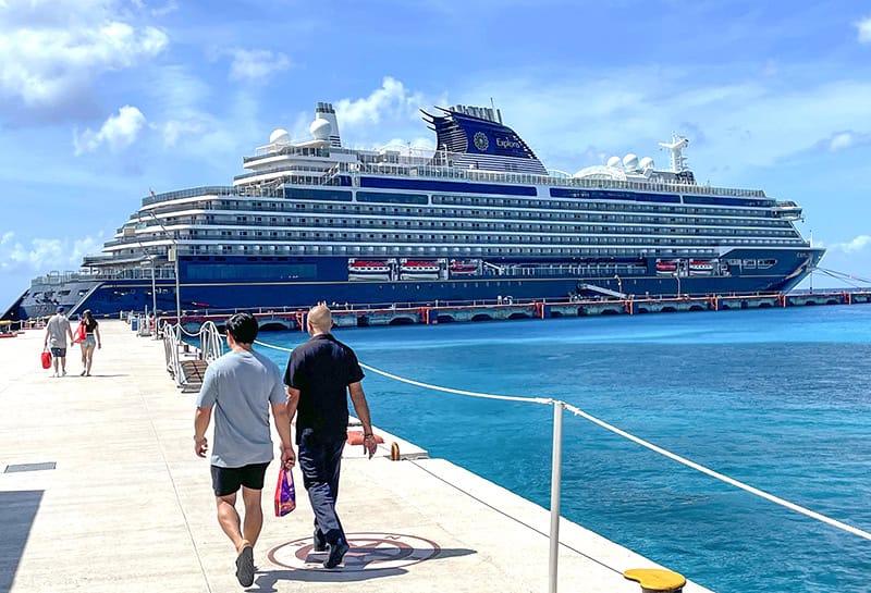 two men walking towards the Explora 1 at a dock