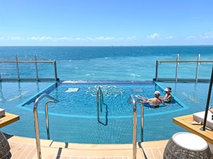 a couple in a pool on the stern of the Explora 1