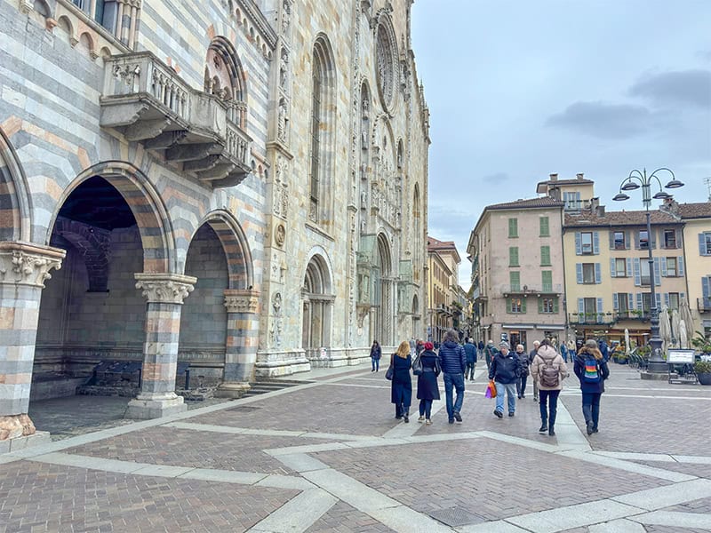 people walking through an old town in a city on Lake Como