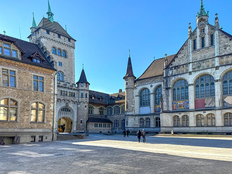 people walking towards the entrance of a beautiful old building see during a 3 days in Zurich vacation