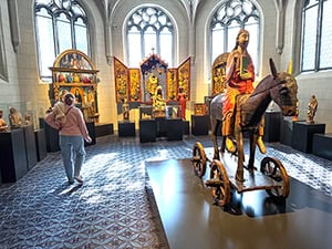an ancient wooden statue in a museum