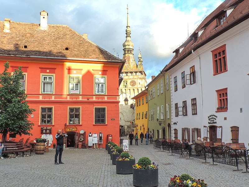 people walking down a narrow street in an eastern European festivals city