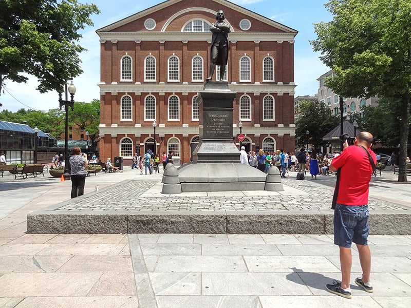 a man taking a photo of an old building visited on a  Freedom Trail Boston self-guided tour