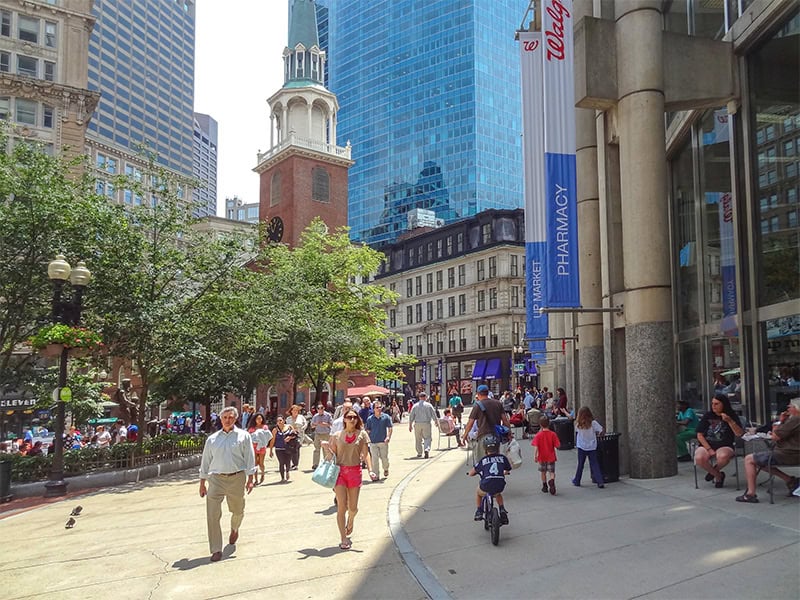people walking along a city street on a  Freedom Trail Boston self-guided tour