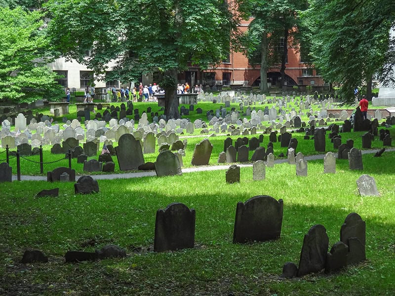 people in an old graveyard visited on a  Freedom Trail Boston self-guided tour